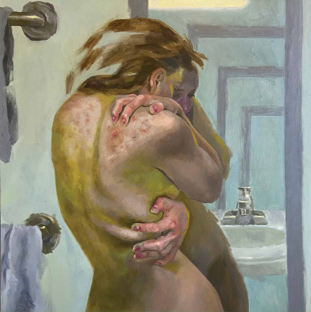 Person grabbing themself around their body standing in front of the mirror in the bathroom.